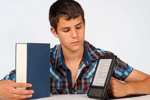Student comparing a traditional  book with its modern version