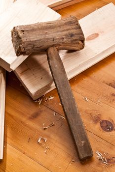 tools series: wooden hammer on table and plank