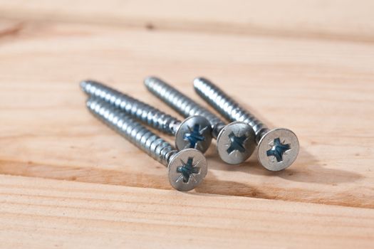 tools series: long screws on wooden table