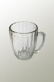 An empty beer mug isolated on gray background.