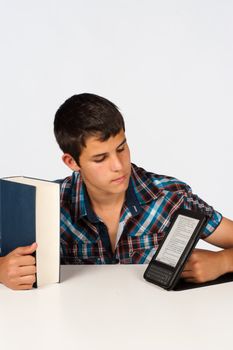 Teenage student with a conventional and an electronic book