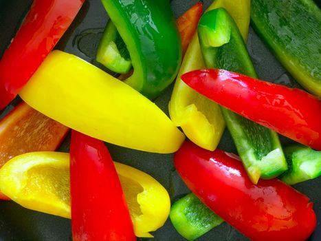 close up of bell peppers in frying pan