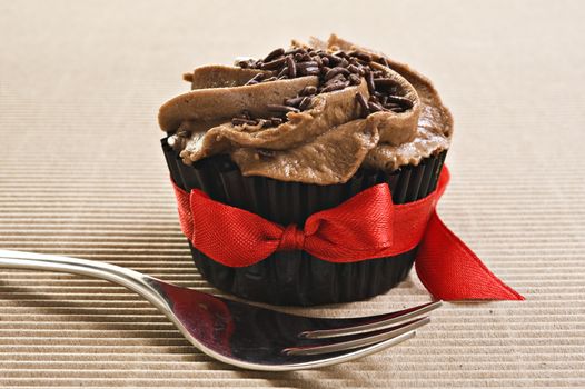 Cup cake with red bow and fork