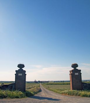 Gate open on a road with blue sky