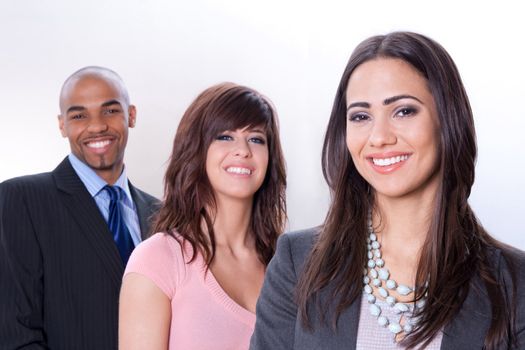 Happy multiracial business team, three young smiling people.
