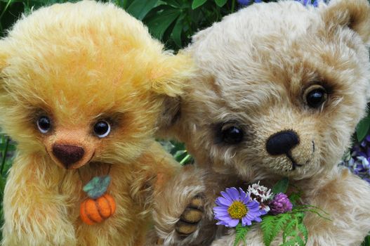 Handmade, the sewed toys: two friends teddy bears among flowers