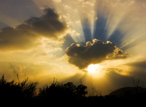 Image of sun shine through rain cloud