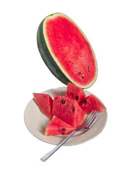 Pieces of fresh watermelon in dish with fork ready to eat