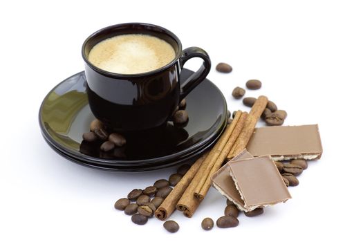cup of italian espresso with cinnamon, coffee beans and chocolate