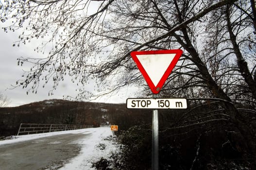 Roadsign at winter road