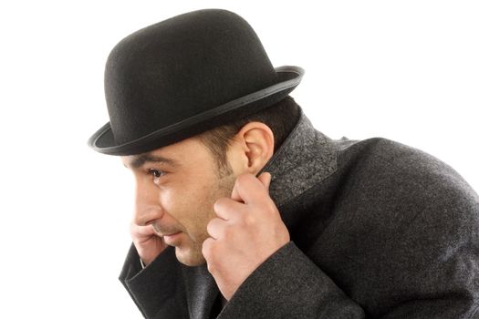 Portrait of a man with bowler hat  hiding from the cold