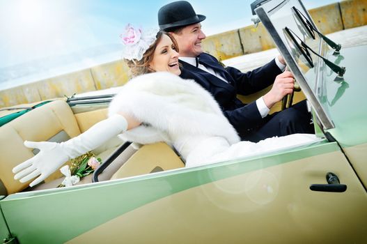 the newly married couple drive retro wedding car