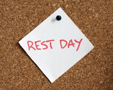 Close up of rest day reminder attach to cork board