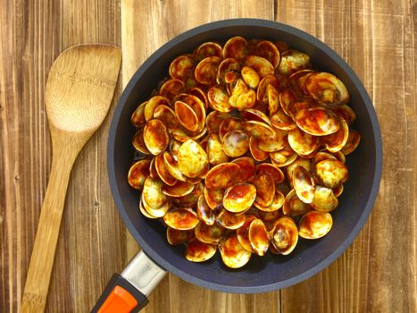 pan of chili clams on kitchen table