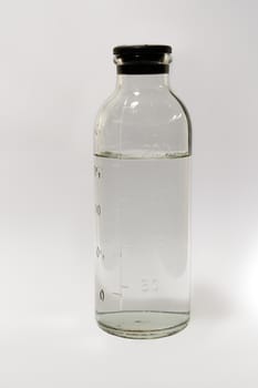 Medical glass bottle with a label dimensional on a white background.