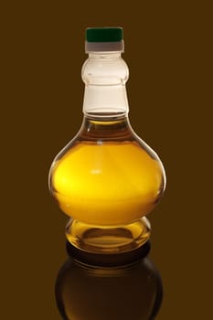 A bottle of sunflower oil, close-up, isolated on a dark background.