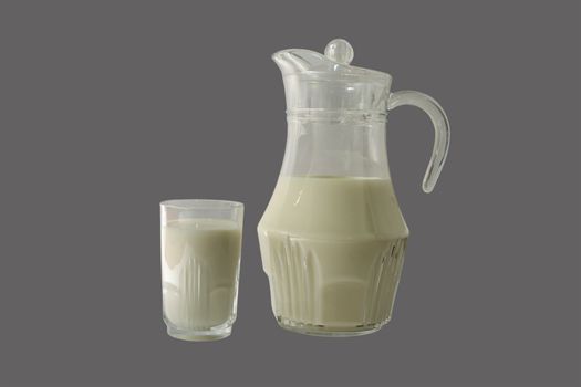 Carafe and glass of milk isolated on gray background.