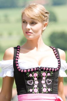 Portrait of a young Bavarian woman with cleavage