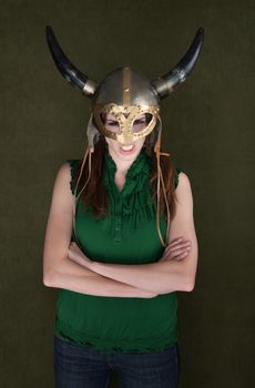 Angry woman with folded arms in Viking helmet