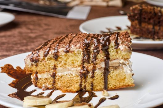 Dessert cakes with banana and coffee at table