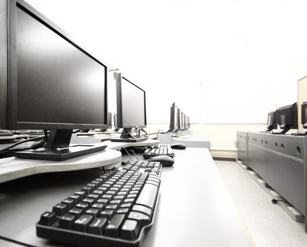 workplace room with computers in row 