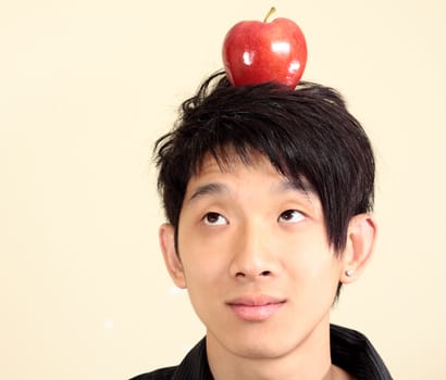 young man with an apple on his head 