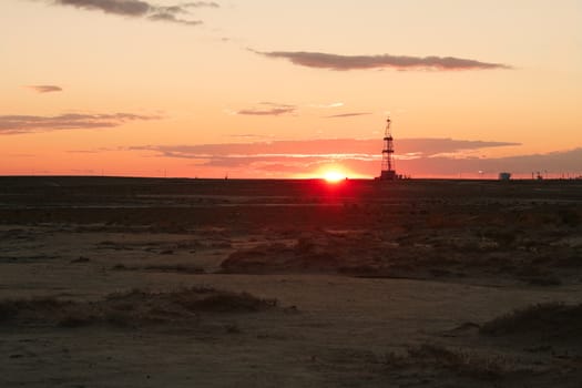 Drilling rig at sunset the sun. Western Kazakhstan.