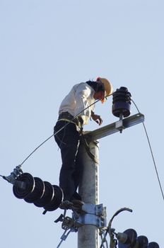 This man maintains the power lines. Relatively well equipped in comparison with other professions in the country. He climbed the pounded with special claws at his feet. But to keep a note customary, he is barefoot!