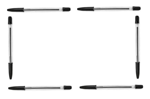 Four black biro pens arranged to form a border around a plain white background