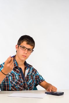 Teenager working for his maths subject with a calculator