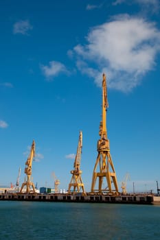 Cranes of the dockyards of Cadiz in a sunny day