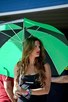 JEREZ DE LA FRONTERA, SPAIN - APR 17:  Unknown pitbabe of Kawasaki Ninja Cup of the CEV Championship, posing in the pitlane before begin the race on April 17, 2011, in Jerez de la Frontera , Spain