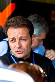 JEREZ DE LA FRONTERA, SPAIN - APR 17:  Team leader and ex-world champion of 125cc of the team CatalunyaCaixa Repsol, Emilio Alzamora attending to the public before the race of 125cc of the CEV on April 17, 2011, in Jerez de la Frontera , Spain