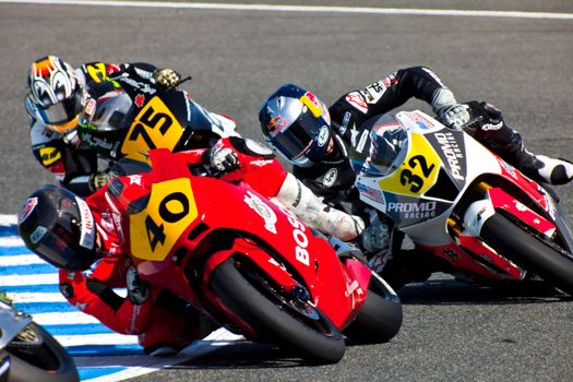 JEREZ DE LA FRONTERA, SPAIN - APR 17: Moto2 motorcyclist Roman Ramos, Jake Gagne and Tomoyoshi Koyama takes a curve in the CEV Championship race on April 17, 2011 in Jerez de la Frontera, Spain.