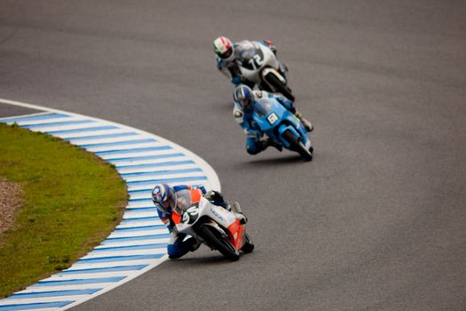 JEREZ DE LA FRONTERA, SPAIN - NOV 20: Pilots Taylor MacKenzie, Andre Pires and Federico Fazzina of motorcycling of 125cc in the Spanish championship of velocity (CEV) on Nov 20, 2010, in racetrack of velocity of Jerez de la Frontera