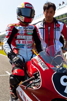 JEREZ DE LA FRONTERA, SPAIN - APR 17: 125cc motorcyclist Mori Syunya waiting on the starting gates in the CEV Championship race on April 17, 2011 in Jerez de la Frontera, Spain.