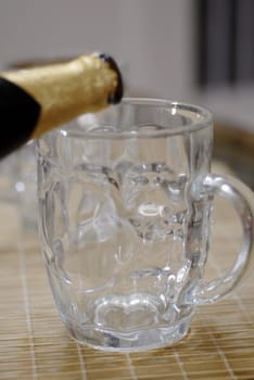 isolated shot of beer poured in a glass from a bottle