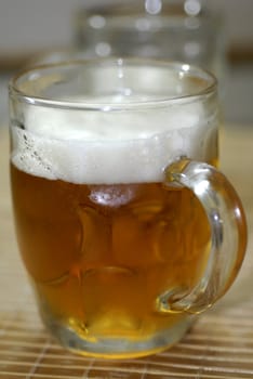 isolated shot of beer poured in a glass from a bottle