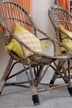 rattan stick Cane furniture chair with orange cushions home interior