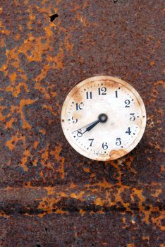 rusted time symbol -old clock-face on rusted tin background