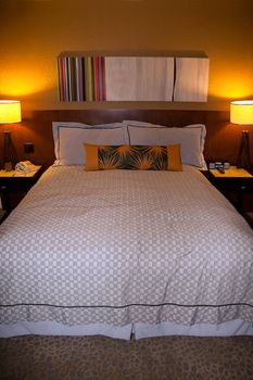 A queen size hotel bed and lights