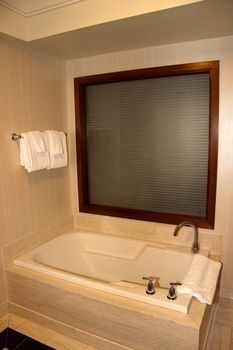 A empty bathtub with window beyond