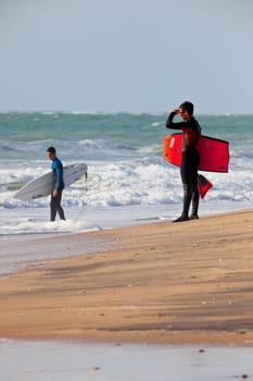 SAN FERNANDO, CADIZ, SPAIN - FEB 19: Unknown bodyboader and surfer on the 2nd championship of Surf and BodyBoard Impoxibol on Feb 19,2011 on the beach of Camposoto of San Fernando, Cadiz, Spain