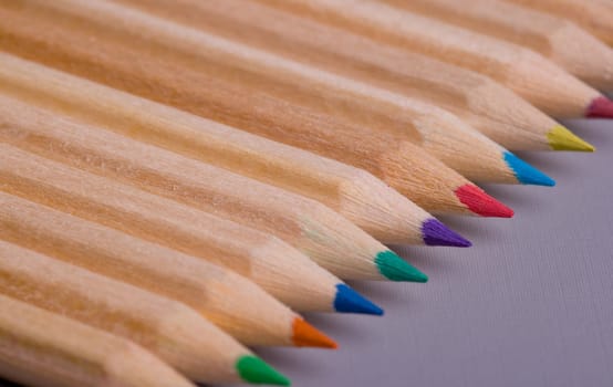 A composition of pencils of wood in a variety of colors