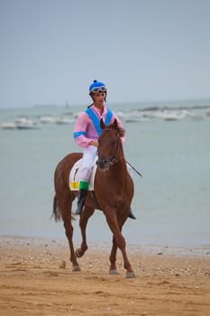 SANLUCAR DE BARRAMEDA, CADIZ, SPAIN - AUGUST 07: Horses races on August 07, 2010 on the beach of Sanlucar de Barrameda, Cadiz, Spain. The races of Sanlucar de Barrameda  are one of the most important horses races of the world