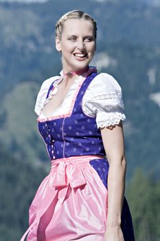 Beautiful girl on a Bavarian alpine meadow in the mountains
