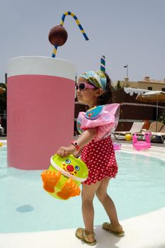 Child is playing by pool