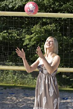 Young woman playing beach volleyball on the beach