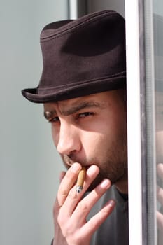 Portrait of a young man smoking cigar 