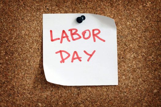 Close up of labor day reminder attach to cork board